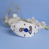 Betty Cooper Iniziale Embroidered Headband in White with Evil Eye